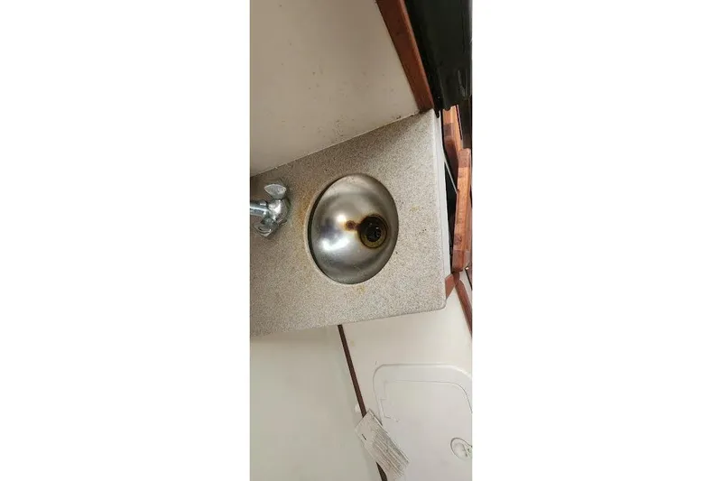 Slide: The Image of Stainless steel sink in 2002 Pursuit 3070 Express boat interior. - 10