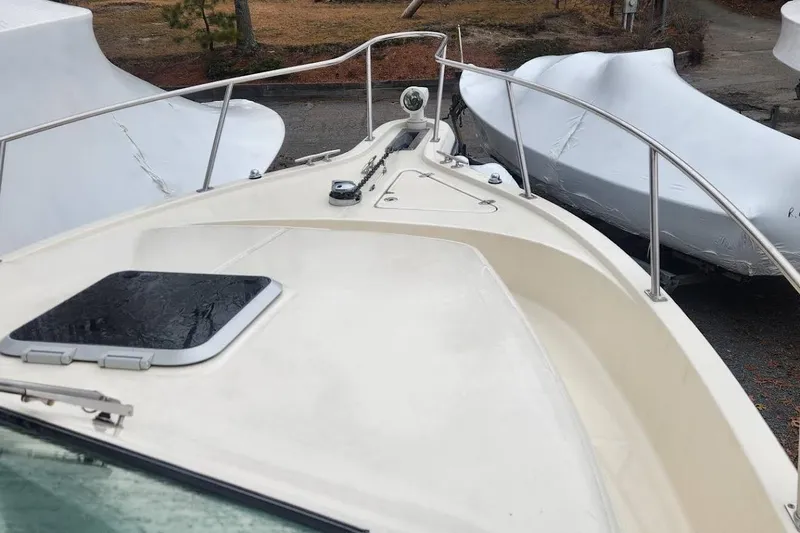 Slide: The Image of 2003 Pursuit 3070 Express boat with twin Suzuki 300 outboard engines. - 13