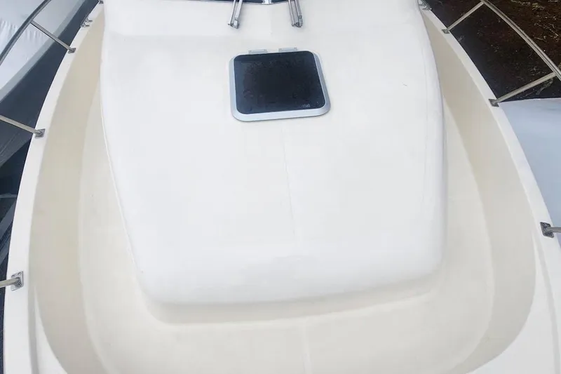 Slide: The Image of 2003 Pursuit 3070 Express boat with Suzuki outboard motor, docked outdoors. - 14