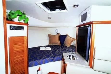 Slide: The Image of Compact bathroom in 2002 Pursuit 3070 Express boat with toilet and sink. - 21