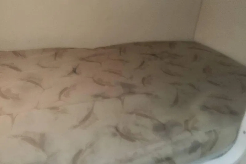 Slide: The Image of 2003 Pursuit 3070 Express boat interior with sink and fire extinguisher. - 22