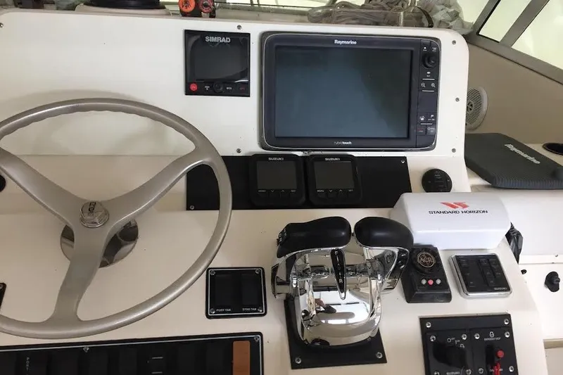 Slide: The Image of Helm of 2002 Pursuit 3070 Express boat with navigation equipment and controls. - 3