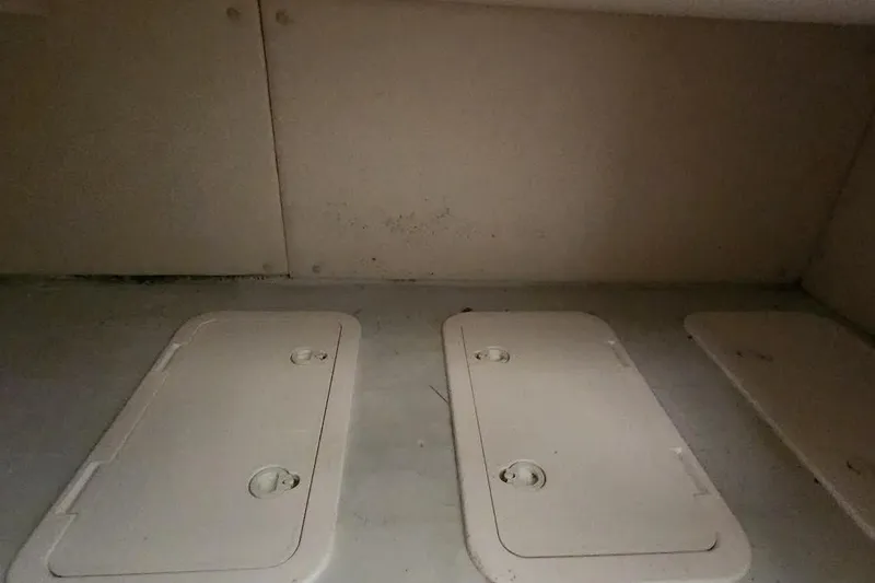 Slide: The Image of Storage compartments inside a 2002 Pursuit 3070 Express boat. - 9