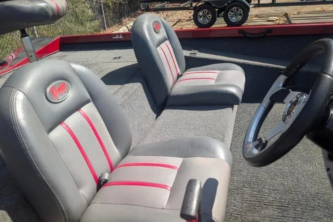 Slide: The Image of 2015 Ranger RT188 boat interior with gray and red seats, steering wheel visible. - 6