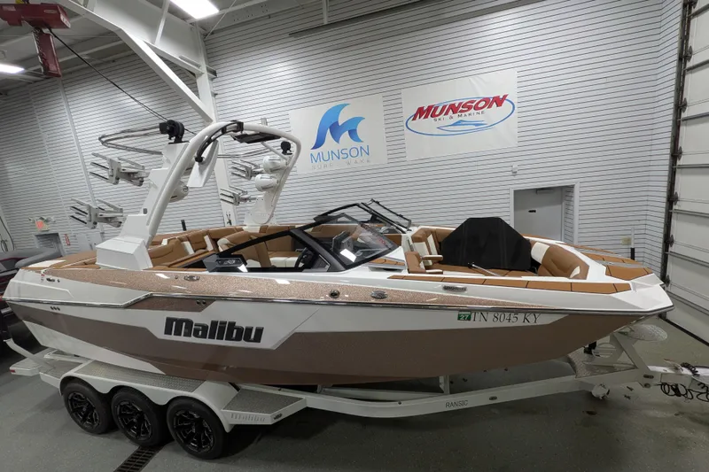 The Image of 2021 Malibu M240 boat in showroom, featuring sleek design and luxury seating. - 0