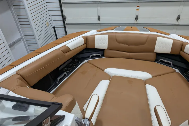 Slide: The Image of 2021 Malibu M240 boat interior with tan and white leather seating. - 15
