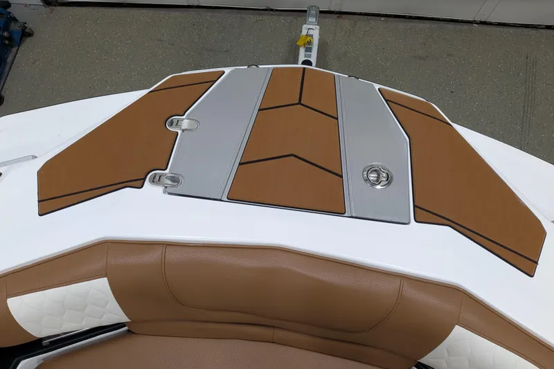 Slide: The Image of 2021 Malibu M240 boat deck with brown and gray accents, featuring sleek design elements. - 17