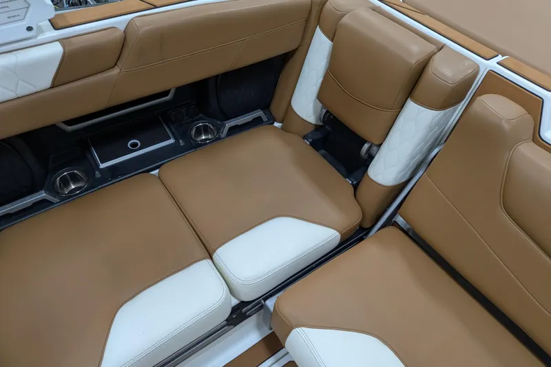 Slide: The Image of 2021 Malibu M240 boat interior with tan and white leather seating. - 19
