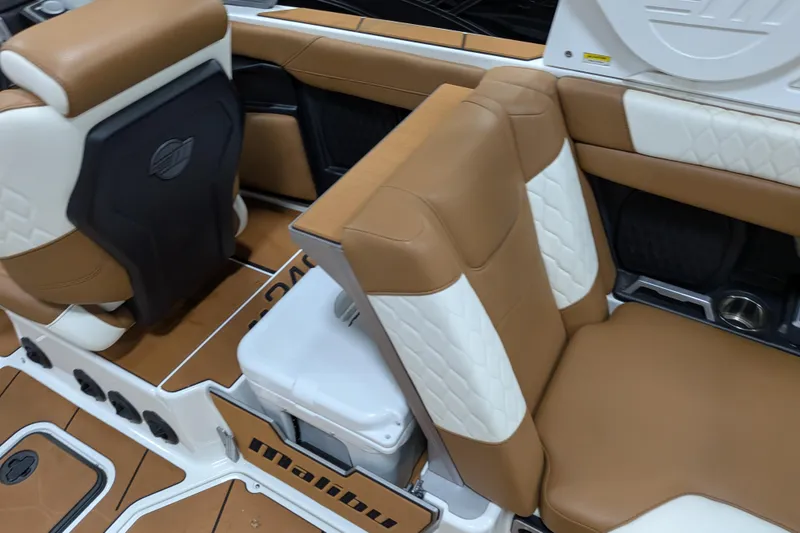 Slide: The Image of 2021 Malibu M240 boat interior with tan and white leather seating. - 20