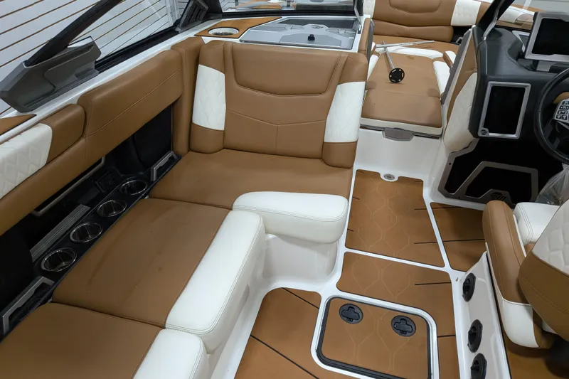 Slide: The Image of Luxurious interior of 2021 Malibu M240 boat with tan and white seating. - 22