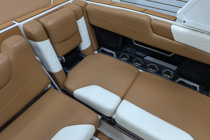 Slide: The Image of Luxurious tan and white seating in a 2021 Malibu M240 boat interior. - 24