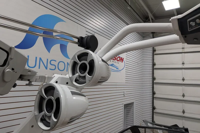 Slide: The Image of 2021 Malibu M240 boat speakers in showroom with branded signage in background. - 26