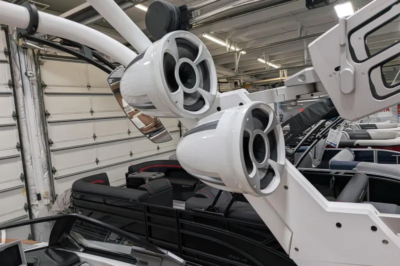 Slide: The Image of 2021 Malibu M240 boat with advanced audio speakers in a showroom. - 28