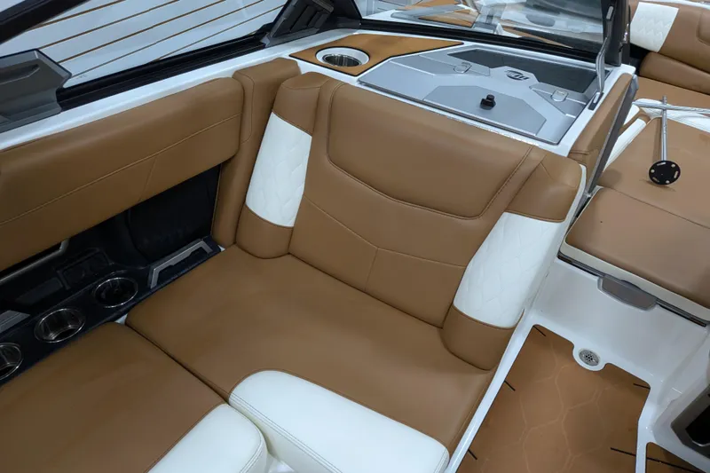 Slide: The Image of 2021 Malibu M240 boat interior with tan and white leather seating. - 31
