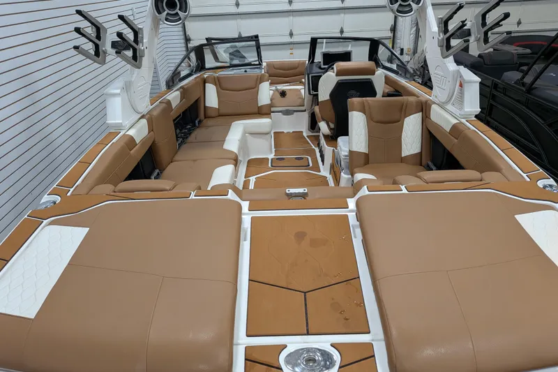 Slide: The Image of 2021 Malibu M240 boat interior with tan and white seating, sleek design, and modern features. - 32