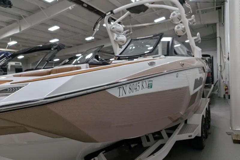 Slide: The Image of 2021 Malibu M240 boat in showroom, showcasing sleek design and modern features. - 6