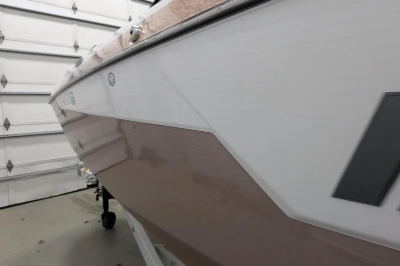 Slide: The Image of 2021 Malibu M240 boat in a garage, showcasing sleek design and modern features. - 8