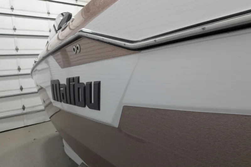 Slide: The Image of 2021 Malibu M240 boat in a garage, showcasing sleek design and branding. - 9