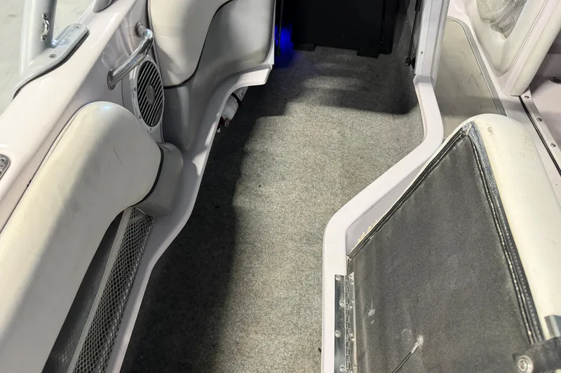 Slide: The Image of 2004 Nautique Sport Nautique SV-211 interior with gray carpet and speaker detail. - 11