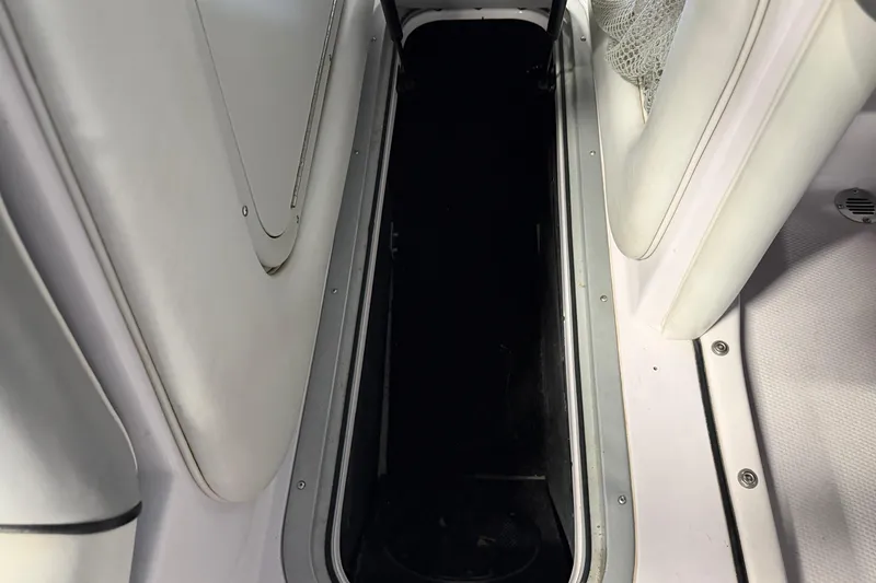 Slide: The Image of 2004 Nautique Sport Nautique SV-211 interior storage compartment with white upholstery. - 12
