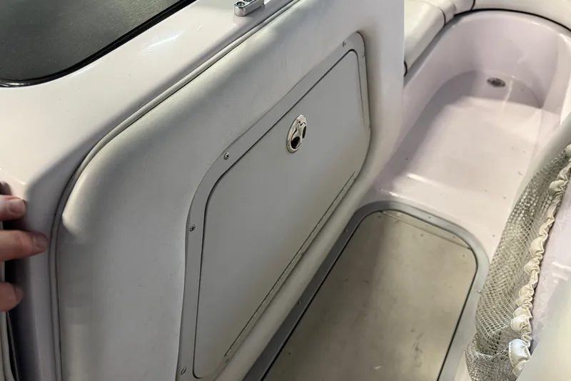 Slide: The Image of 2004 Nautique Sport Nautique SV-211 interior storage compartment and seating area. - 13