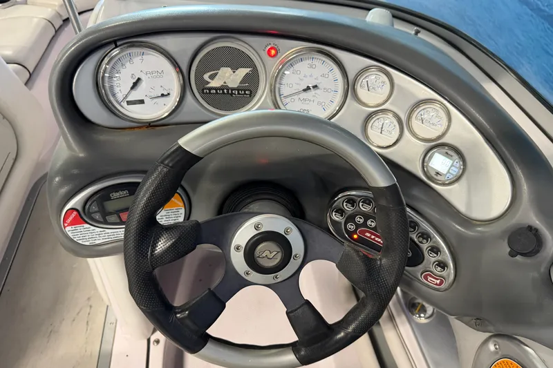 Slide: The Image of Dashboard of a 2004 Nautique Sport Nautique SV-211 boat with steering wheel and gauges. - 15