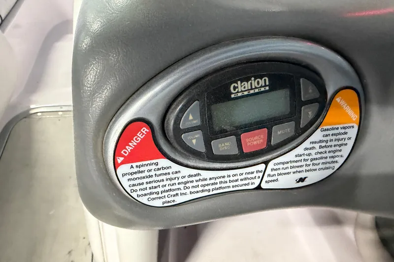 Slide: The Image of 2004 Nautique Sport Nautique SV-211 dashboard with Clarion Marine audio controls and safety warnings. - 16