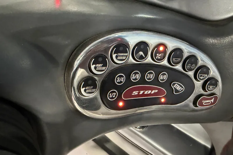 Slide: The Image of Control panel of a 2004 Nautique Sport Nautique SV-211 boat with various function buttons. - 17