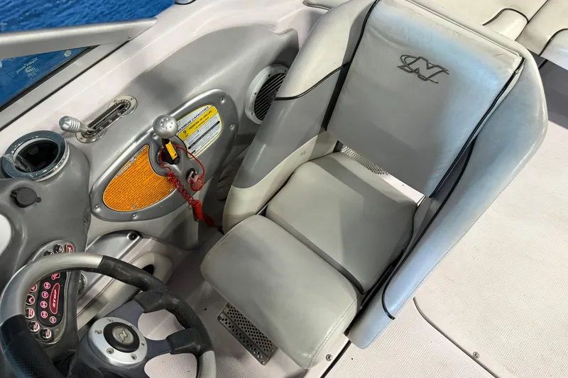 Slide: The Image of 2004 Nautique Sport Nautique SV-211 boat interior with steering wheel and control panel. - 18