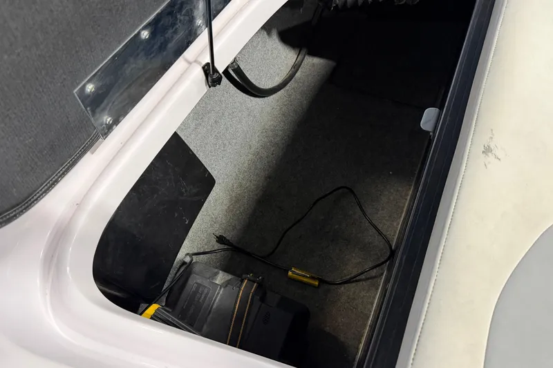 Slide: The Image of 2004 Nautique Sport Nautique SV-211 storage compartment with battery and wiring. - 20