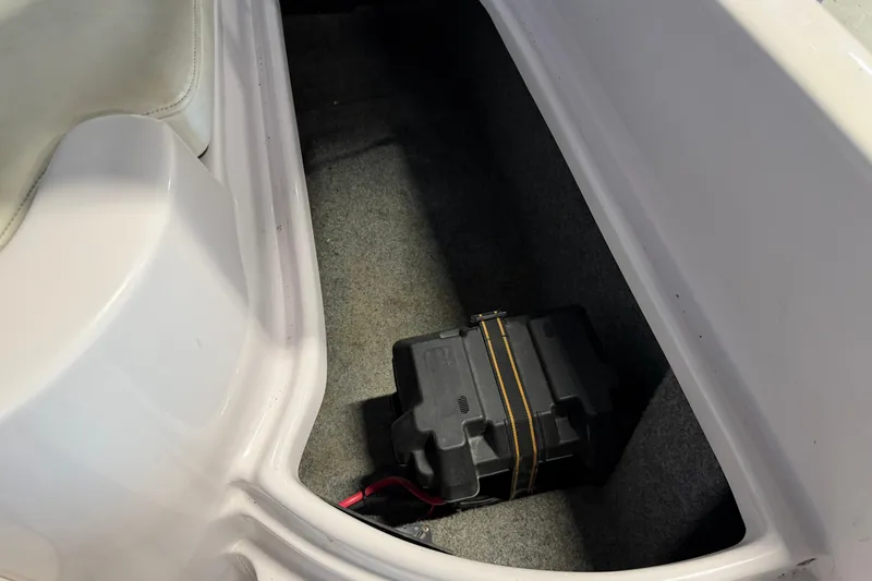 Slide: The Image of 2004 Nautique Sport Nautique SV-211 battery compartment with secured battery. - 22