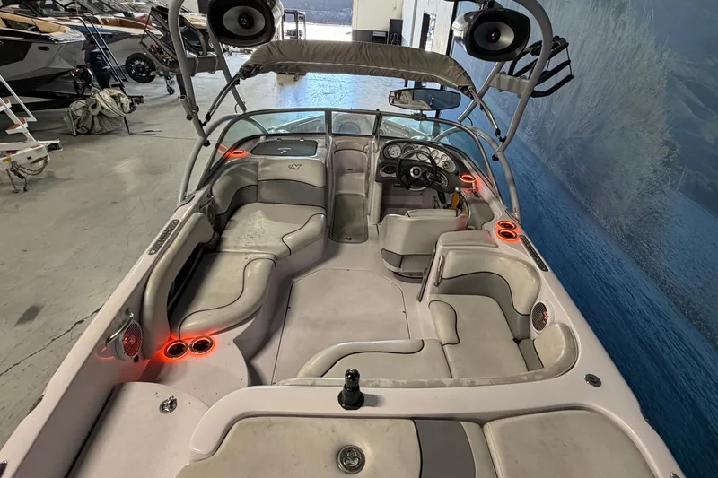 Slide: The Image of 2004 Nautique Sport Nautique SV-211 boat interior with seating, speakers, and dashboard. - 4