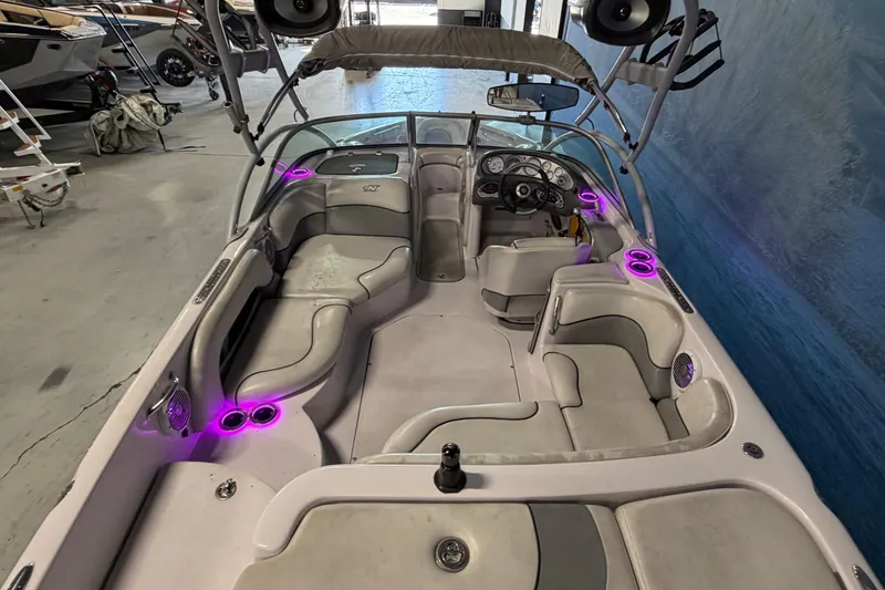 Slide: The Image of 2004 Nautique Sport Nautique SV-211 boat interior with purple LED lights and seating. - 5