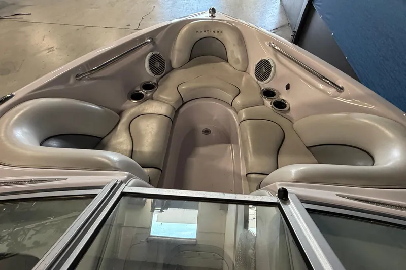 Slide: The Image of 2004 Nautique Sport Nautique SV-211 boat interior with cushioned seating and cup holders. - 6