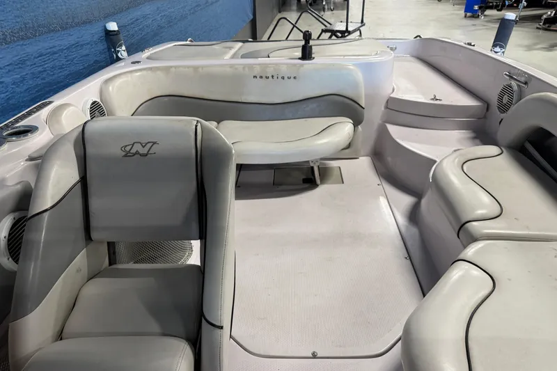 Slide: The Image of 2004 Nautique Sport Nautique SV-211 boat interior with white seating and sleek design. - 8