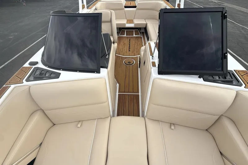 Slide: The Image of 2026 Moomba Max boat interior with beige seating and wooden flooring. - 12
