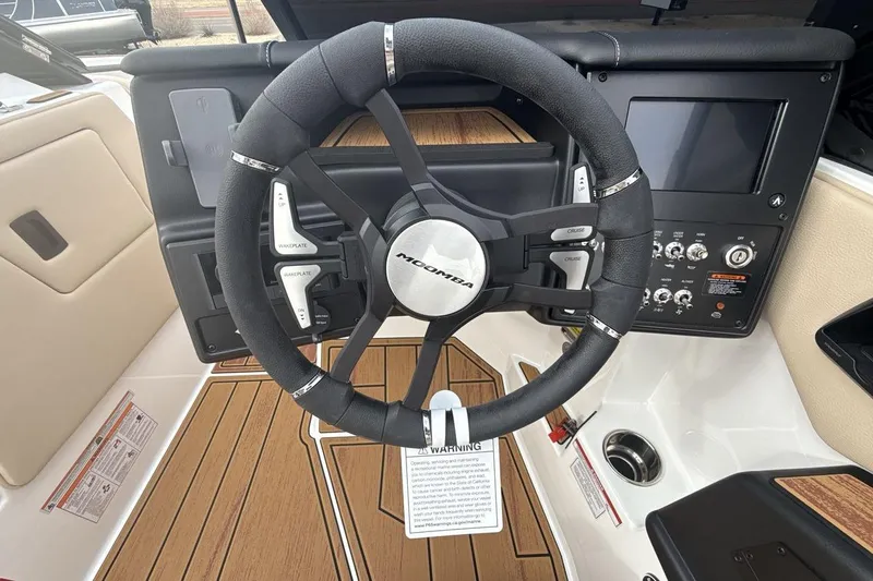 Slide: The Image of 2026 Moomba Max boat dashboard with steering wheel and control panel. - 14