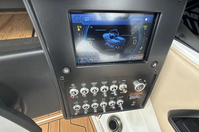 Slide: The Image of 2026 Moomba Max boat dashboard with touchscreen and control switches. - 15