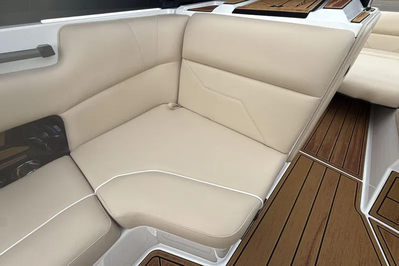 Slide: The Image of 2026 Moomba Max boat interior with beige seating and wood-style flooring. - 17