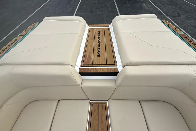 Slide: The Image of 2026 Moomba Max boat interior with beige seating and wood accents. - 19