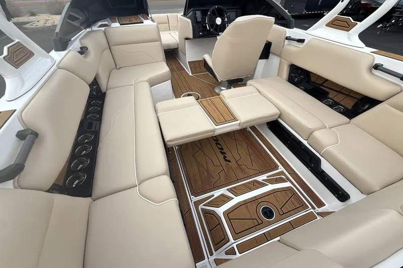 Slide: The Image of Luxurious interior of 2026 Moomba Max boat with beige seating and stylish wood flooring. - 22