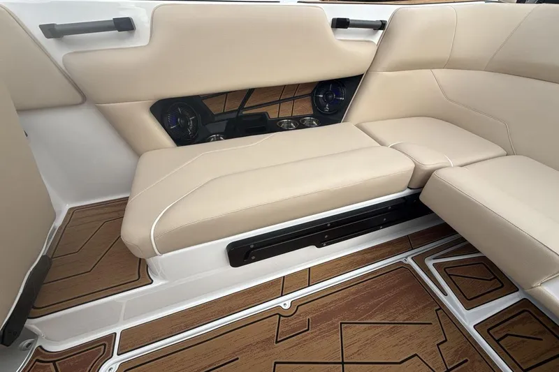 Slide: The Image of 2026 Moomba Max boat interior with beige seating and wood-patterned flooring. - 23