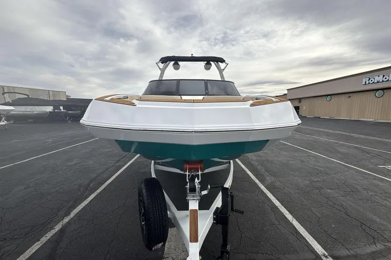 Slide: The Image of 2026 Moomba Max boat on trailer in parking lot, overcast sky. - 8
