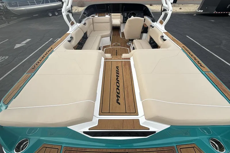 Slide: The Image of 2026 Moomba Max boat interior with beige seating and teak flooring. - 9