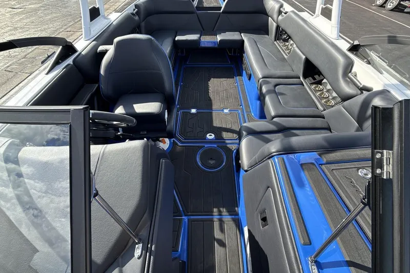 Slide: The Image of 2025 Moomba Mojo boat interior with sleek black and blue seating and modern design. - 12