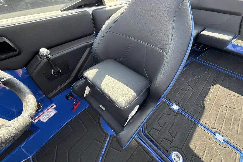 Slide: The Image of 2025 Moomba Mojo interior with black seating and blue accents, showcasing modern design. - 13