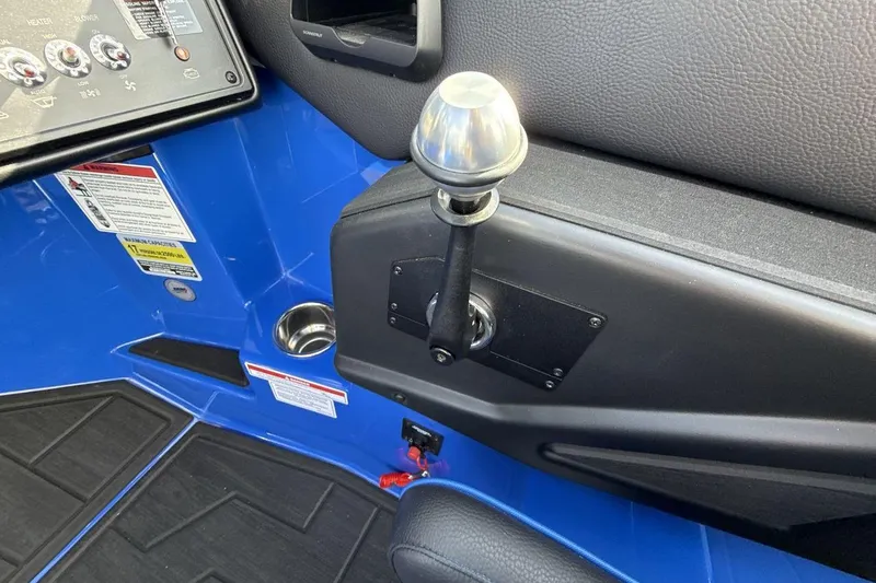 Slide: The Image of 2025 Moomba Mojo boat interior with control panel and gear lever. - 16