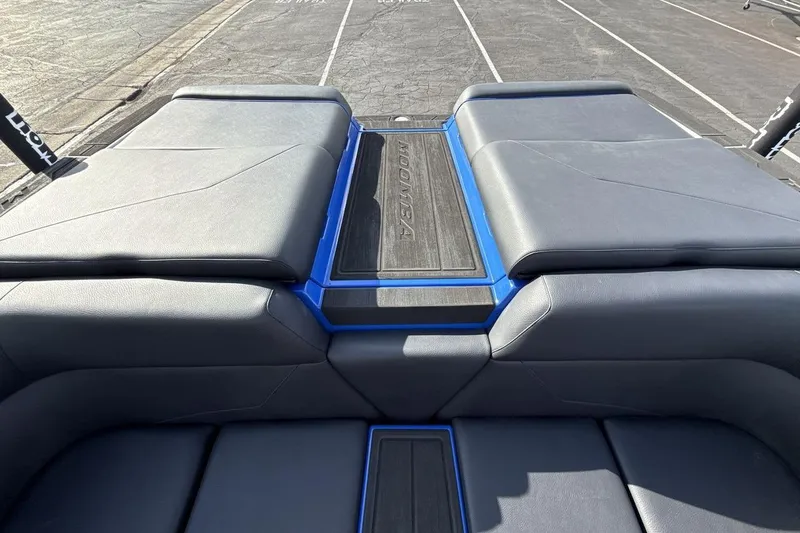 Slide: The Image of 2025 Moomba Mojo boat interior with sleek black seating and blue accents. - 19