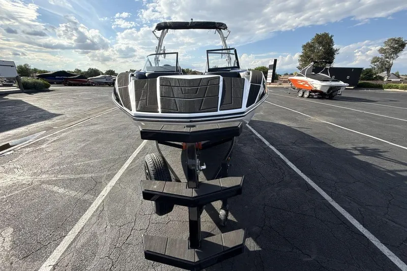 Slide: The Image of 2025 Moomba Mojo boat on trailer in sunny parking lot. - 8