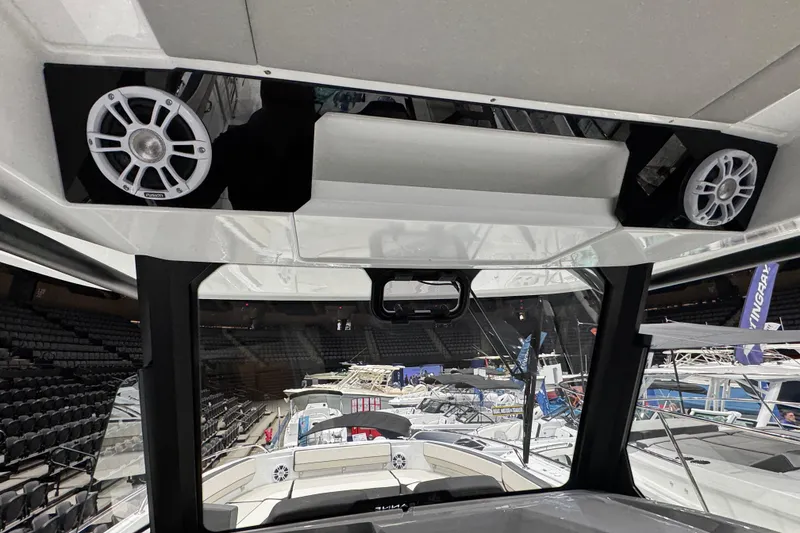 Slide: The Image of Interior view of 2026 Jeanneau Leader 10.5 CC boat with speakers and seating area. - 10